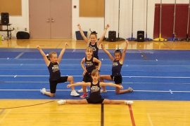 5 little girls doing a cheerleading routine